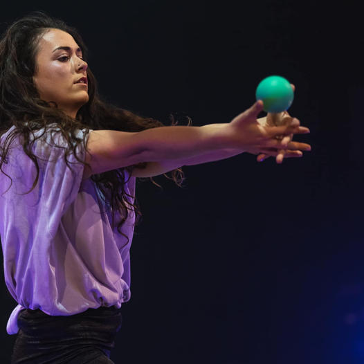 an image of Helena Berry performing with a green ball